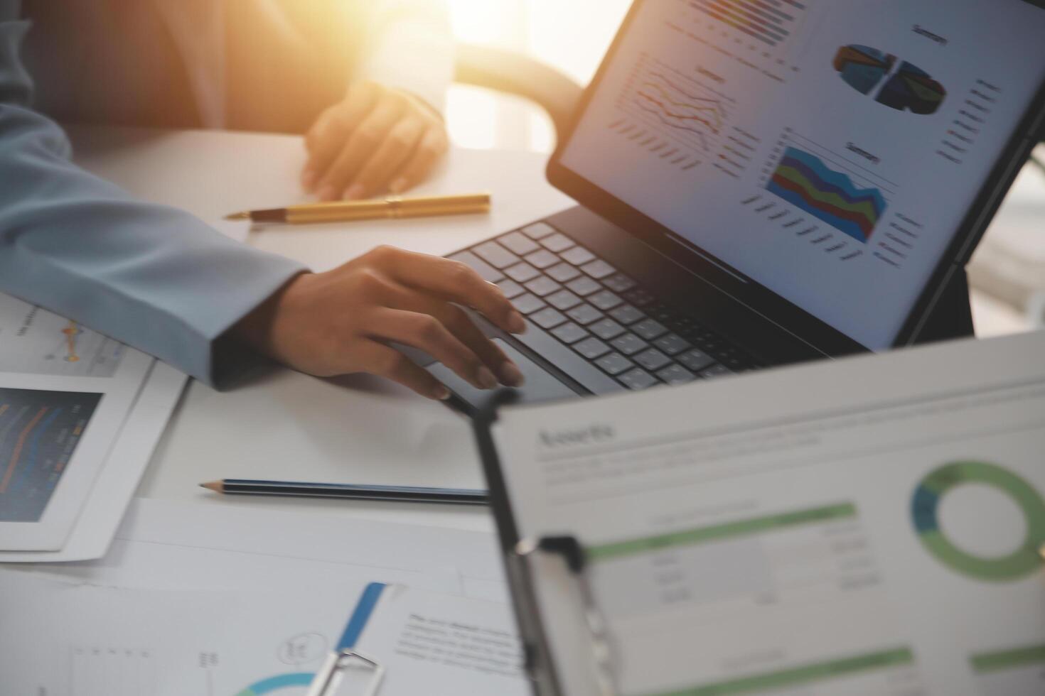 Close up of Business team analyzing income charts and graphs with modern laptop computer. Business analysis and strategy concept. photo