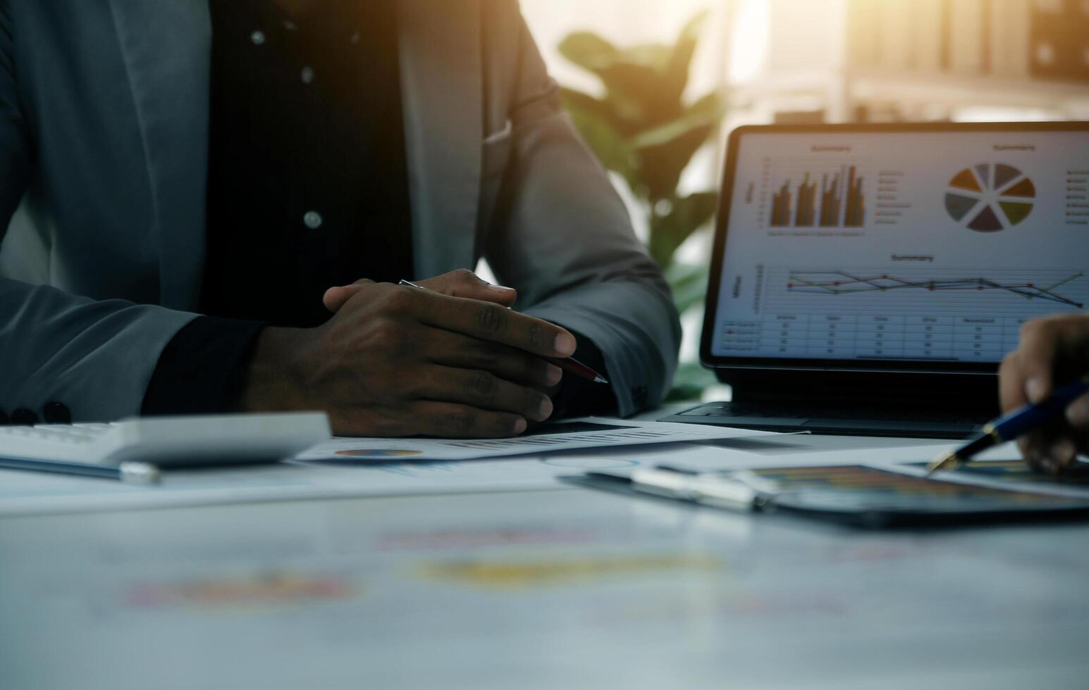 Close up of Business team analyzing income charts and graphs with modern laptop computer. Business analysis and strategy concept. photo