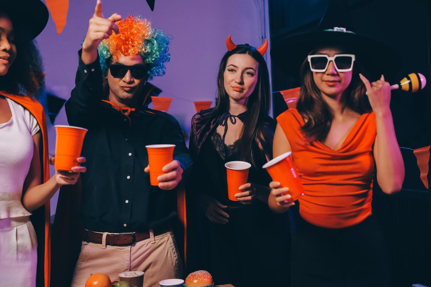 Joyful office Halloween party with coworkers in costumes, celebrating with drinks and laughter, fostering teamwork and festive spirit photo