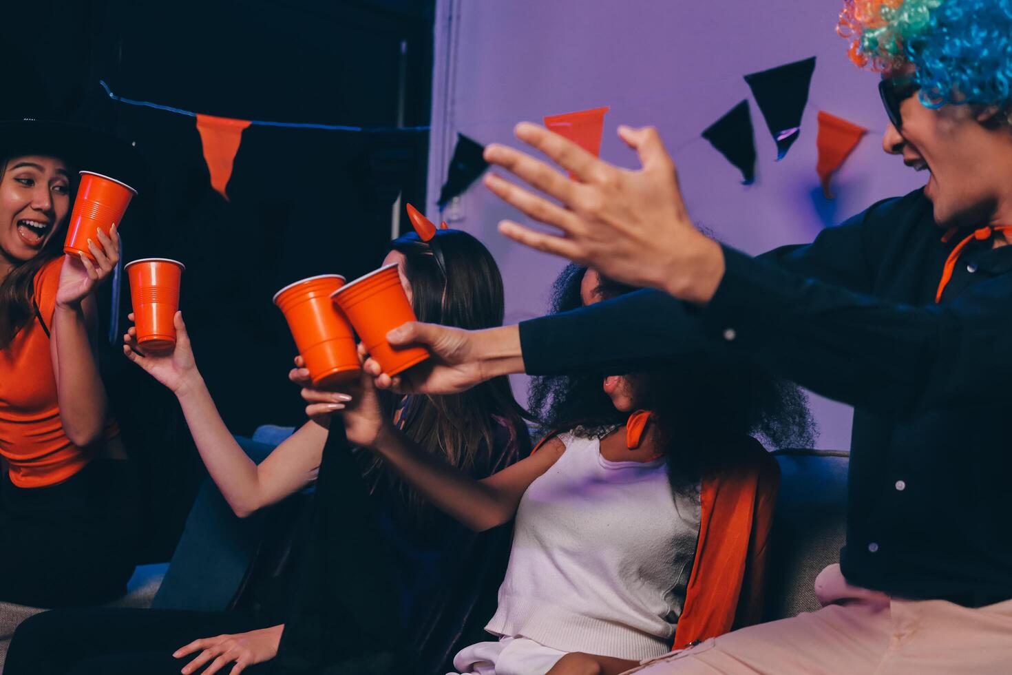 Joyful office Halloween party with coworkers in costumes, celebrating with drinks and laughter, fostering teamwork and festive spirit photo