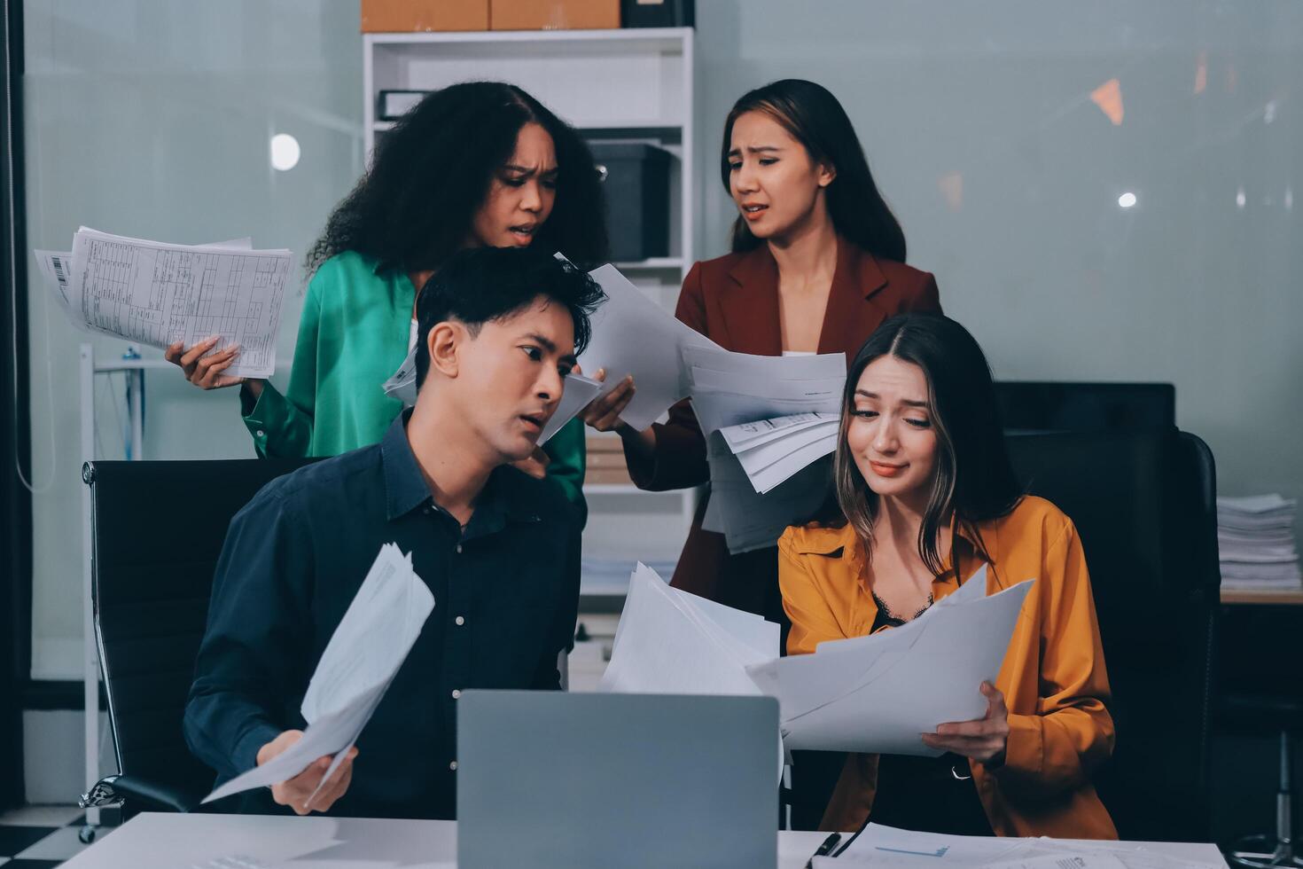 Stress, business people and employee frustrated with multitasking, pressure or overworked by team in chaos with paperwork. Anxiety, headache and worker overwhelmed by group and burnout in crisis photo