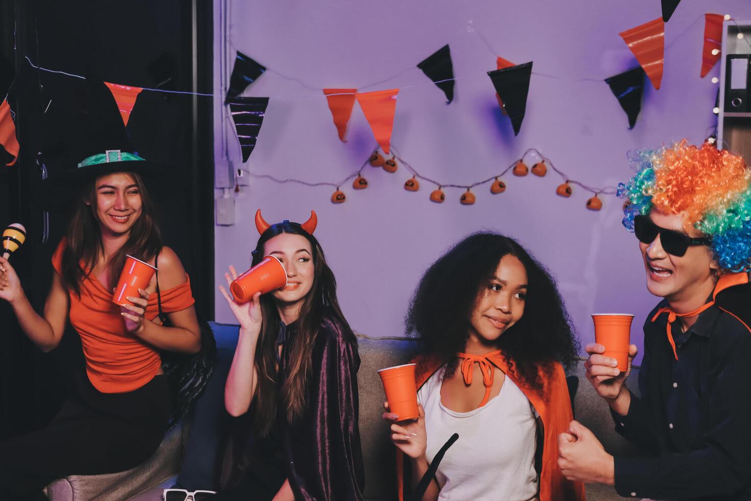 Joyful office Halloween party with coworkers in costumes, celebrating with drinks and laughter, fostering teamwork and festive spirit photo