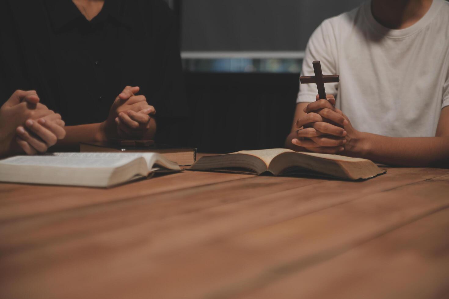 Christian group are praying to god with the bible and sharing the gospel. Concept of faith for god. photo