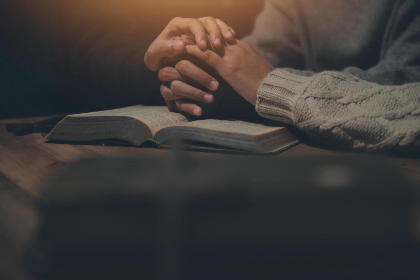 Christian group are praying to god with the bible and sharing the gospel. Concept of faith for god. photo