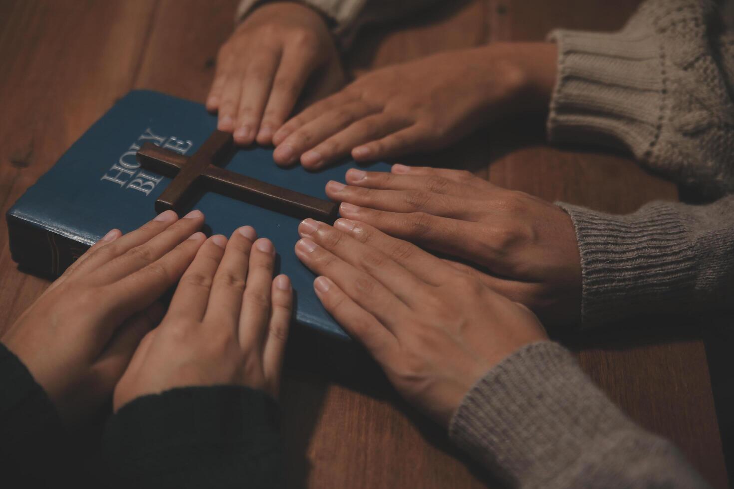 Christian group are praying to god with the bible and sharing the gospel. Concept of faith for god. photo
