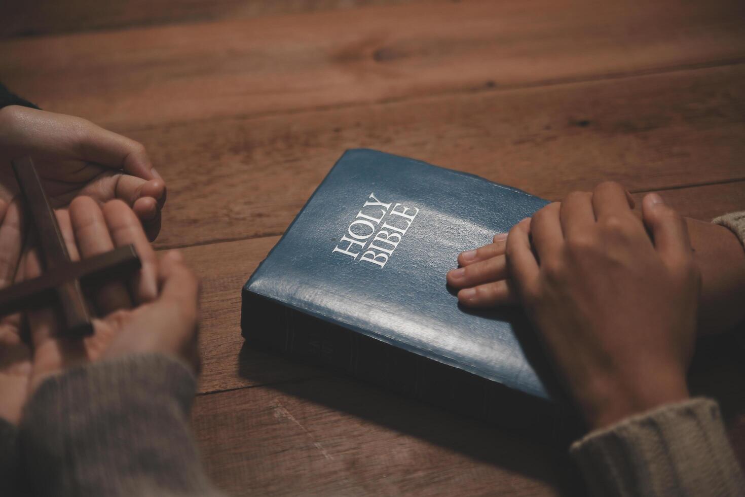 Christian group are praying to god with the bible and sharing the gospel. Concept of faith for god. photo