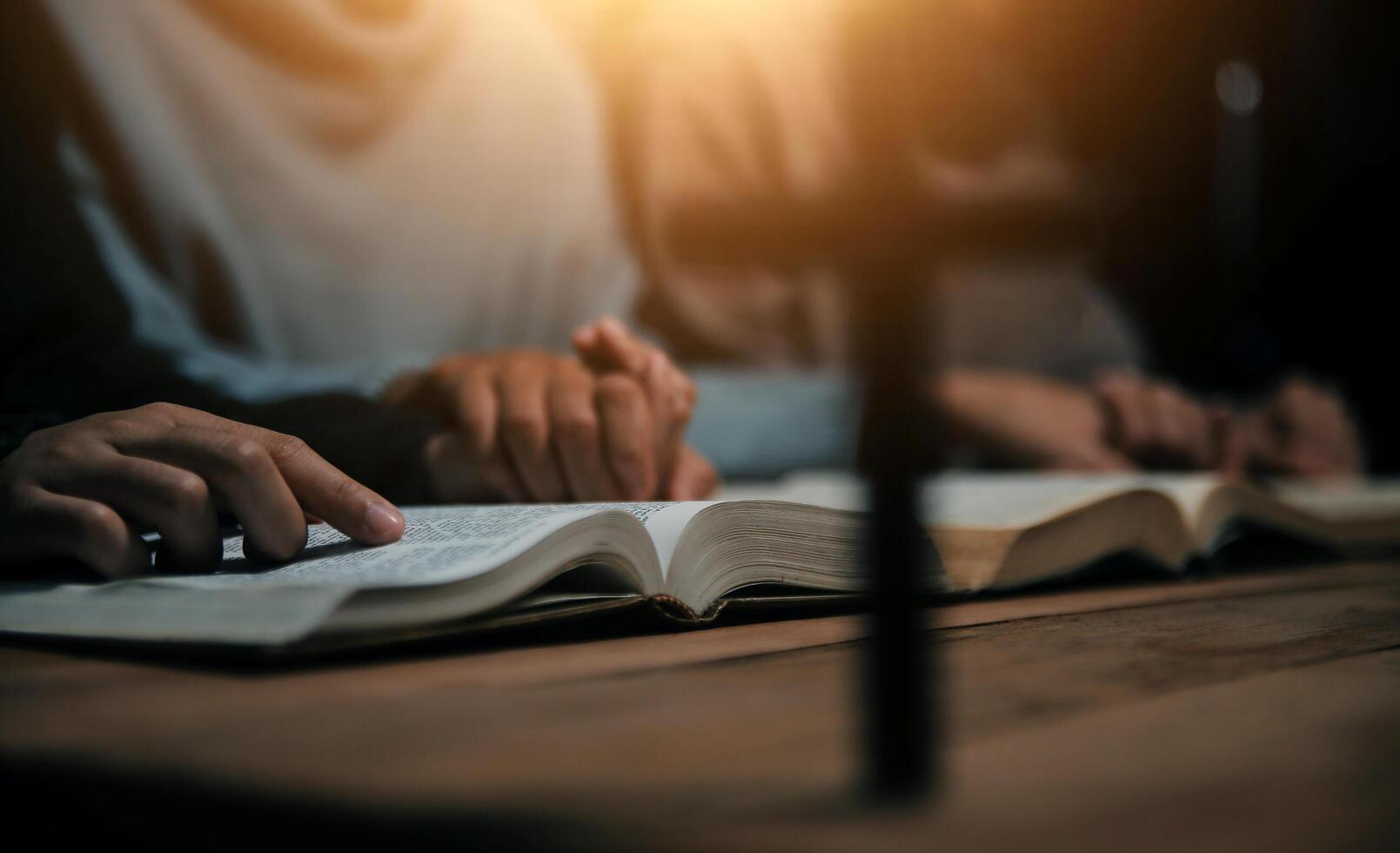 Christian group are praying to god with the bible and sharing the gospel. Concept of faith for god. photo