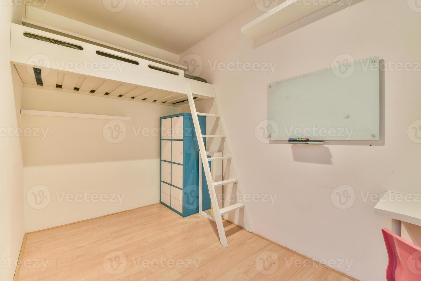 A small room with a ladder and a desk photo
