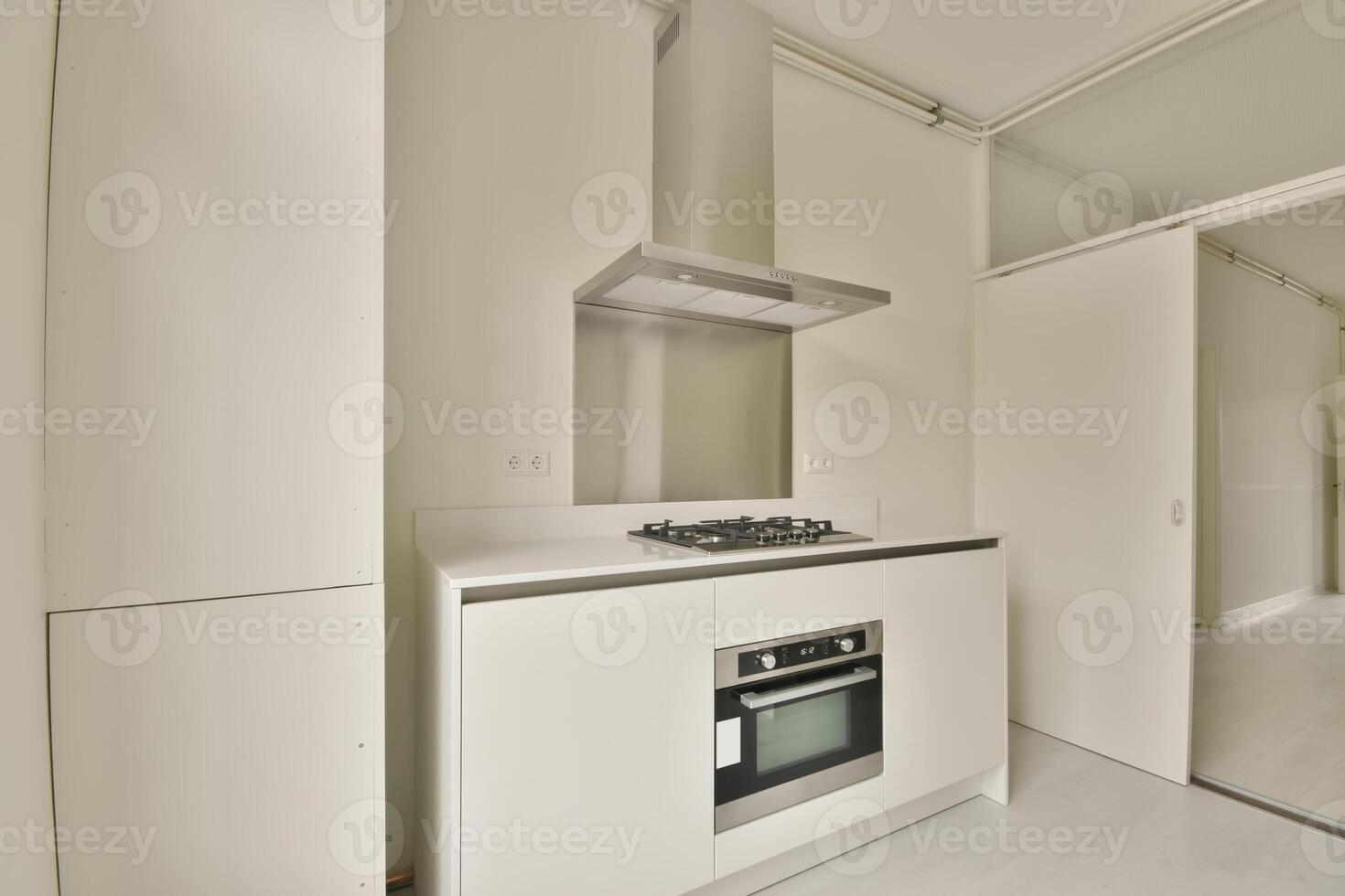 A white kitchen with a stove and oven photo
