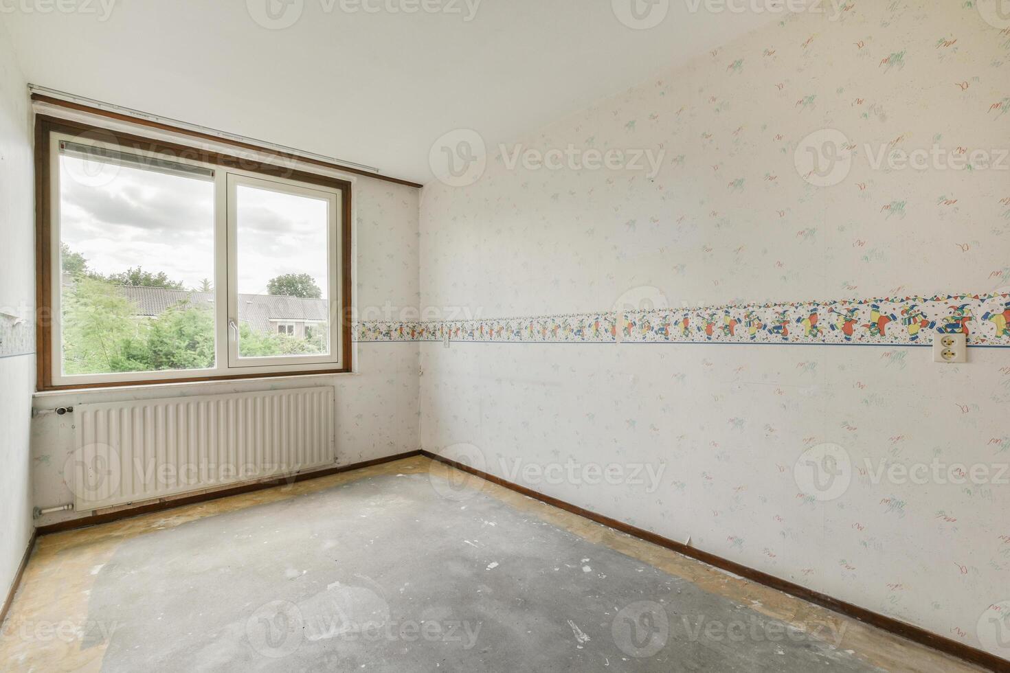 Empty room with wallpaper and a radiator photo