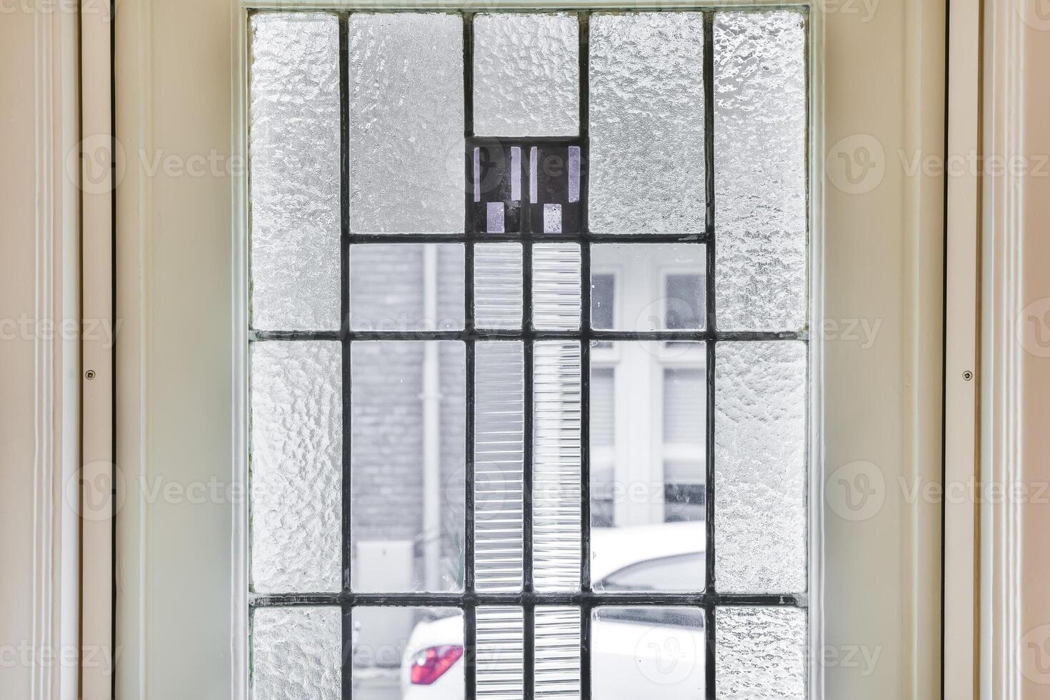 A glass door with a black and white pattern photo