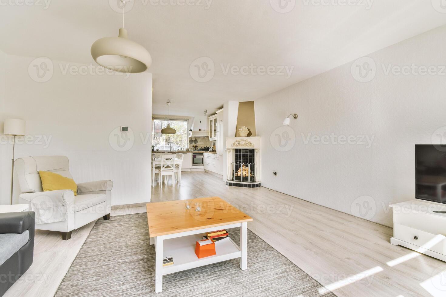 A living room with a white couch, coffee table and television photo
