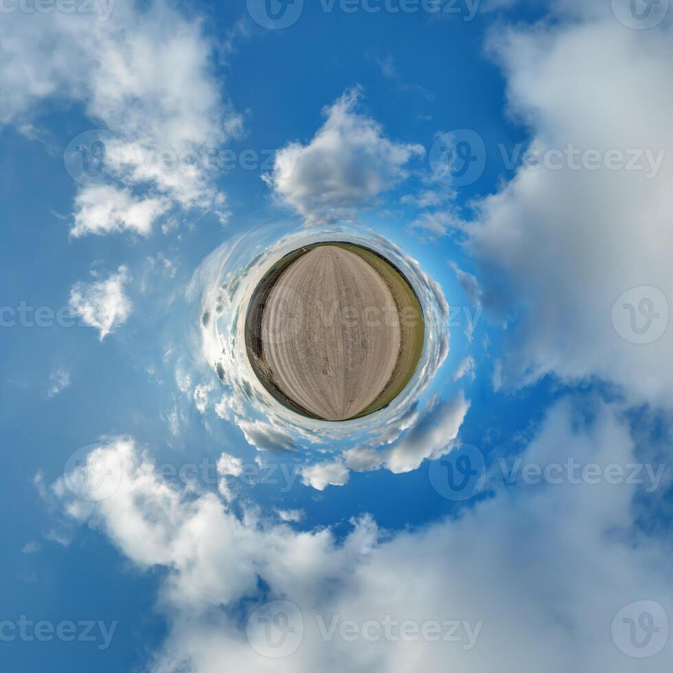 simple little tiny planet without buildings in blue sky with beautiful clouds. Transformation of spherical panorama 360 degrees. Spherical abstract aerial view. Curvature of space. photo