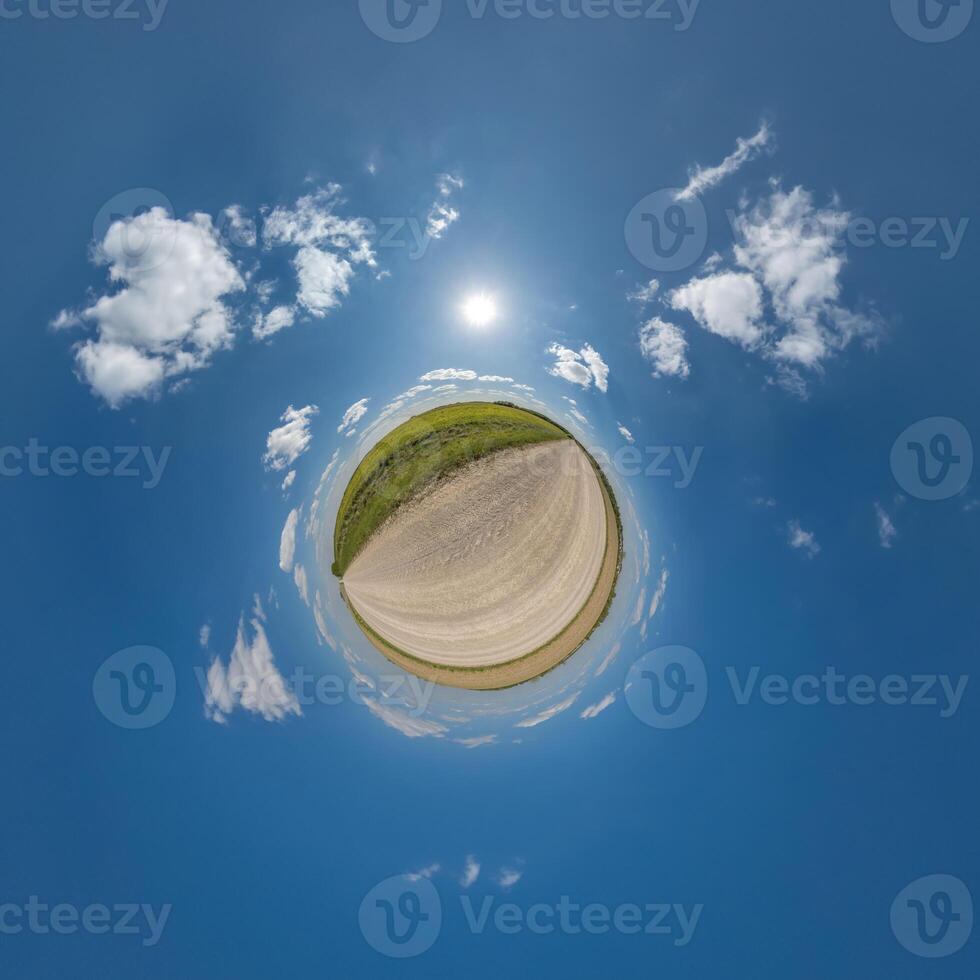 simple little tiny planet without buildings in blue sky with beautiful clouds. Transformation of spherical panorama 360 degrees. Spherical abstract aerial view. Curvature of space. photo