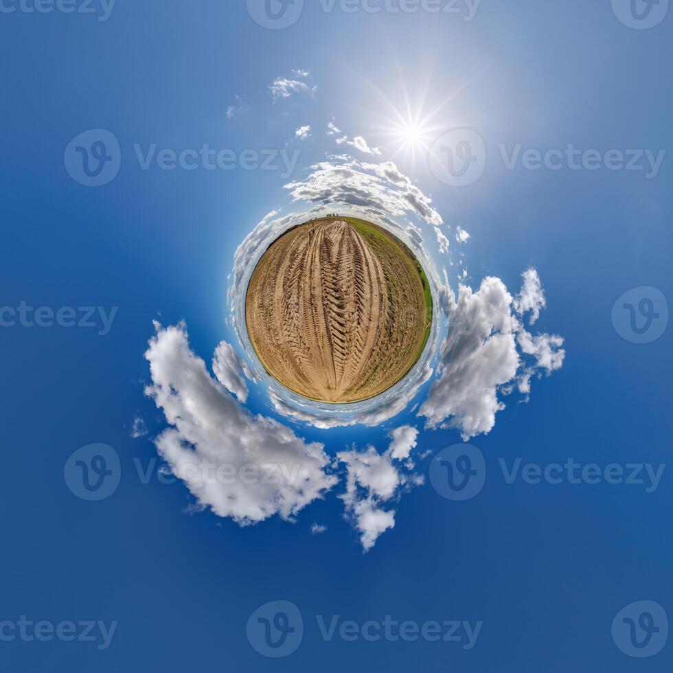 simple little tiny planet without buildings in blue sky with beautiful clouds. Transformation of spherical panorama 360 degrees. Spherical abstract aerial view. Curvature of space. photo