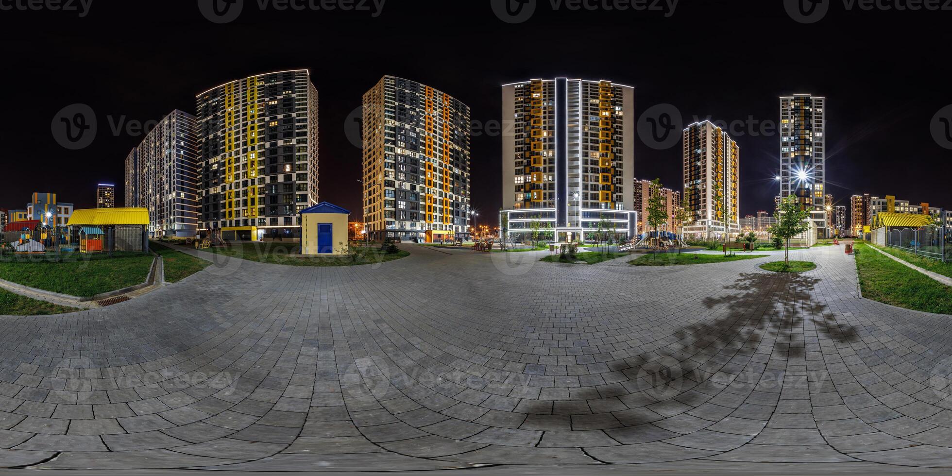 night panorama 360 near skyscraper multistory buildings with illumination of residential quarter complex in full equirectangular seamless spherical projection photo