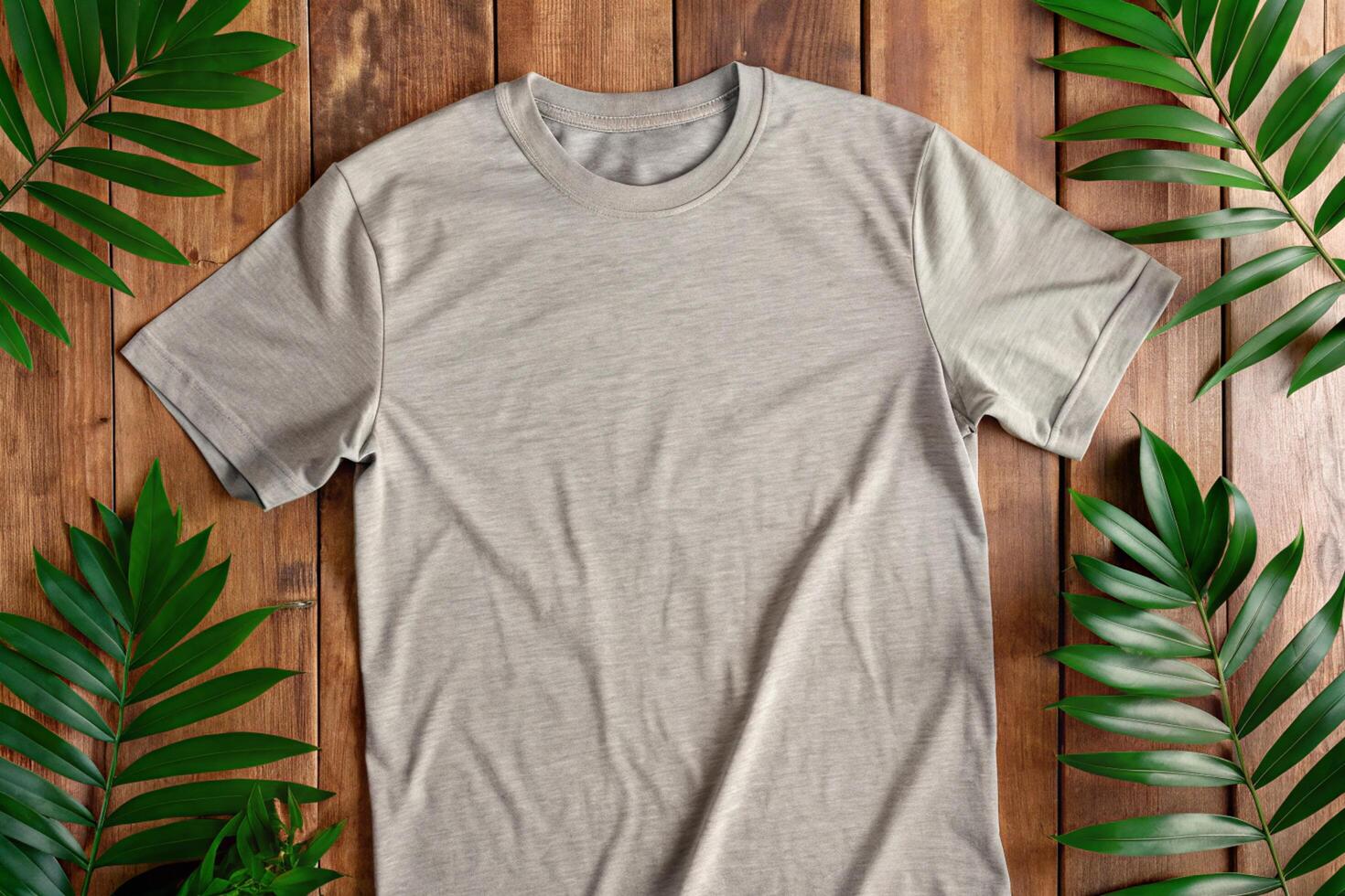 A t - shirt on a wooden table with green leaves photo