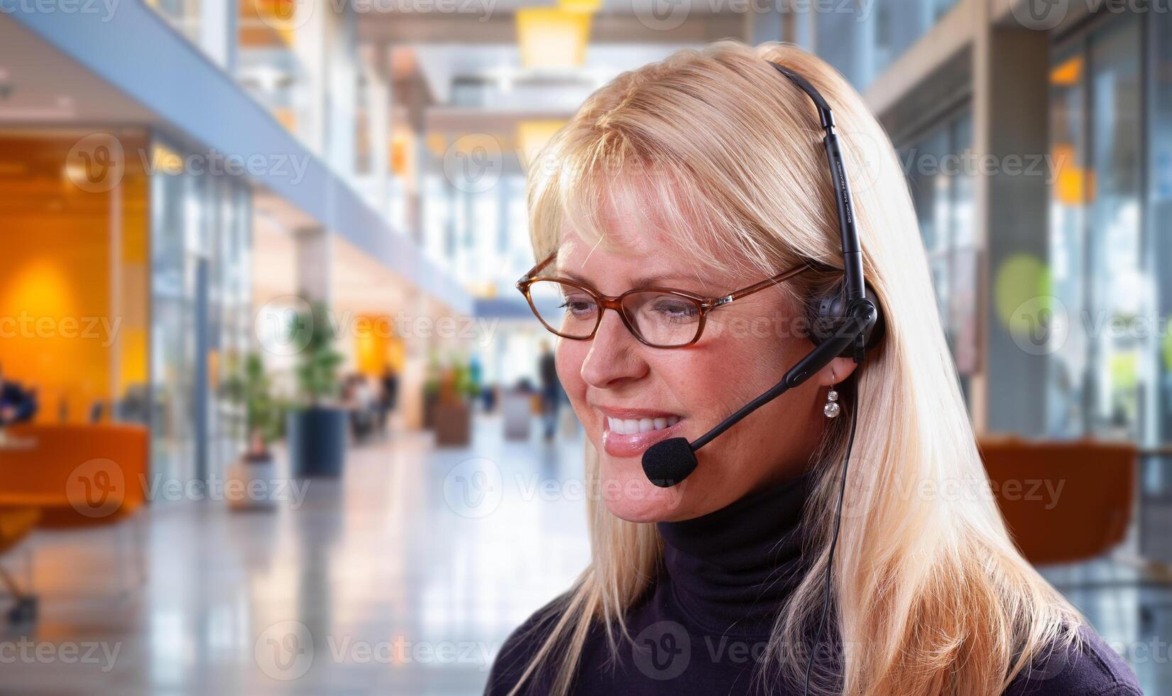 Attractive Businesswoman Wearing Telephone Headset In An Office Setting. photo