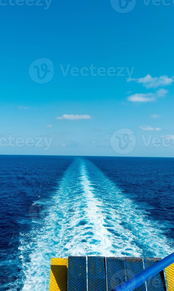 the wake in the sea left by a ferry from Genoa to Palermo during a late August holiday photo