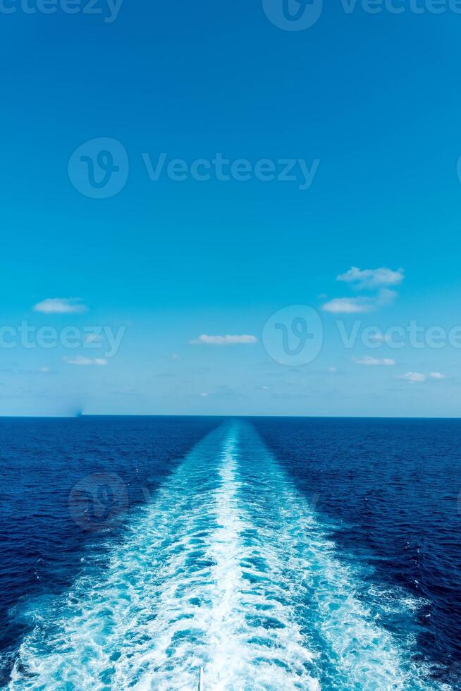 the wake in the sea left by a ferry from Genoa to Palermo during a late August holiday photo