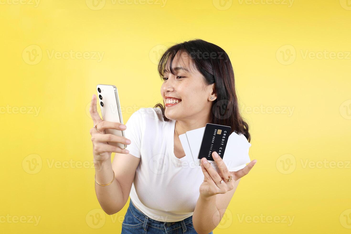Asian Woman Holding Mobile Phone Happy Online Shopping Using Credit Card photo