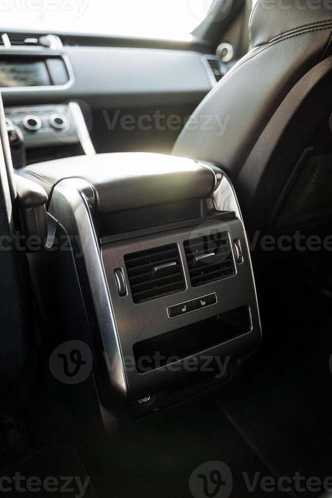 The air duct of the rear seat in the car, the chrome elements of the car, the interior of the car, the interior of an expensive car. photo