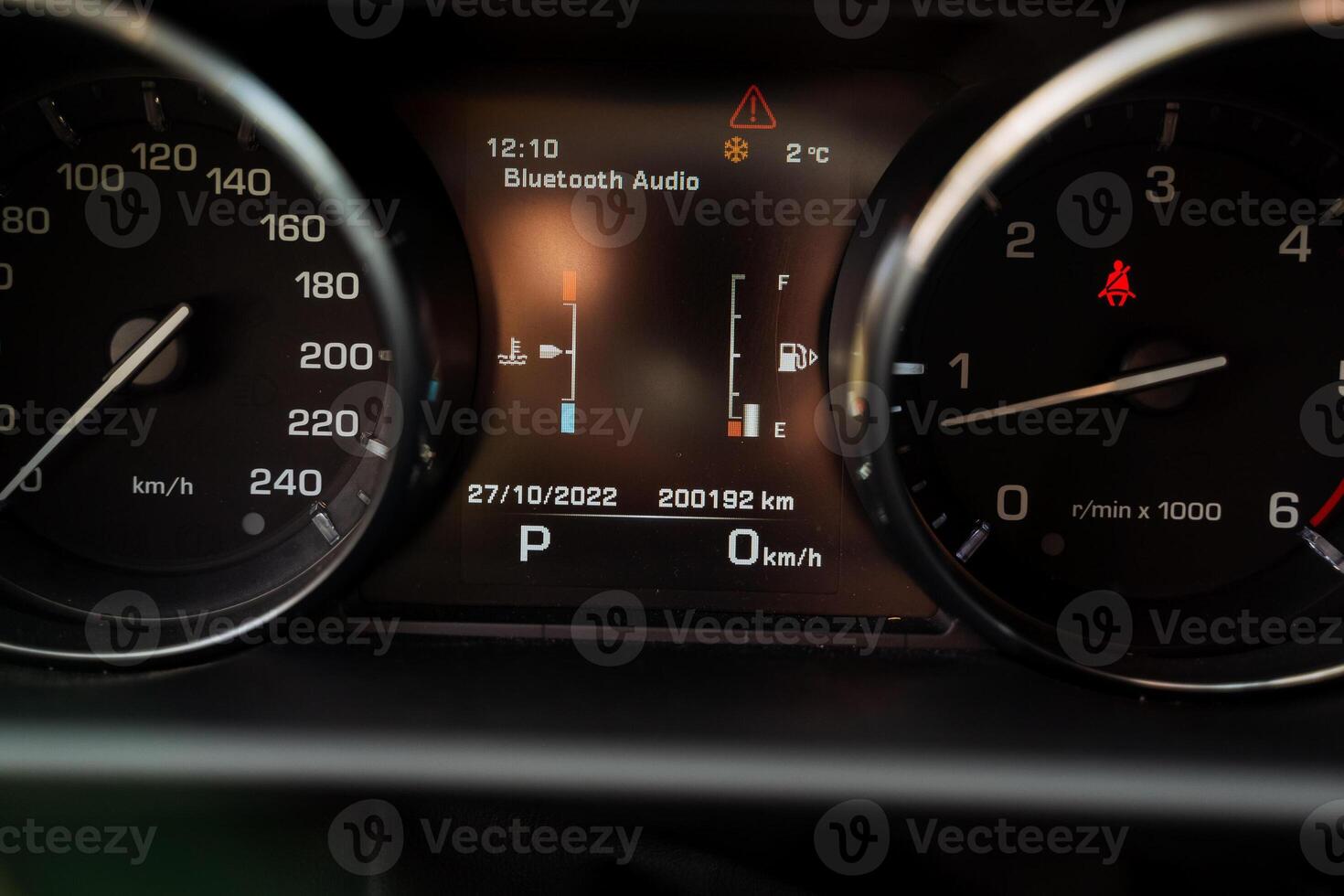 Speedometer in the car, dashboard indicating the speed and revolutions of the car, fuel level sensor in the gas tank, oil temperature in the engine. photo