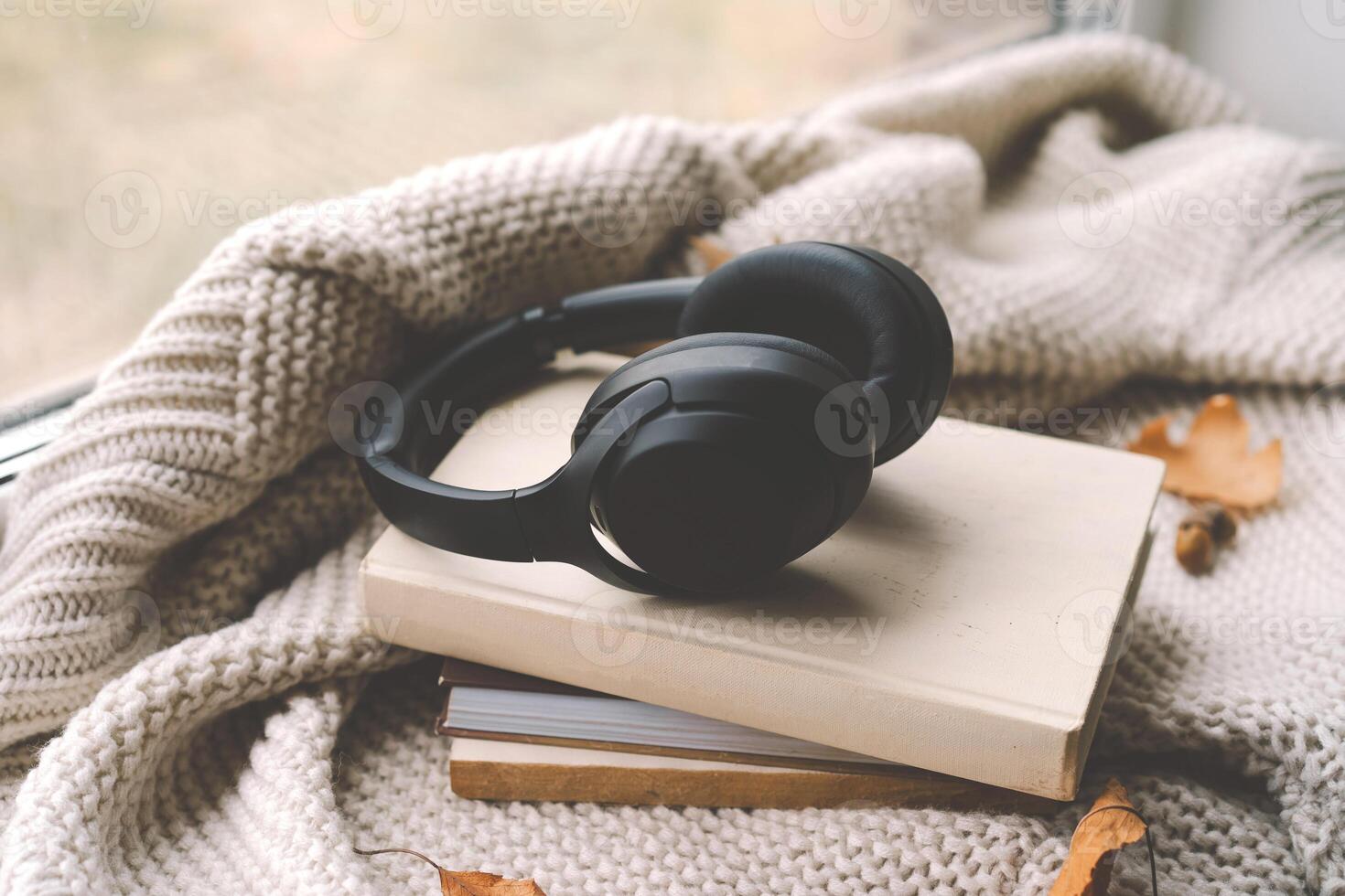 Cozy autumn setting with headphones on a book photo