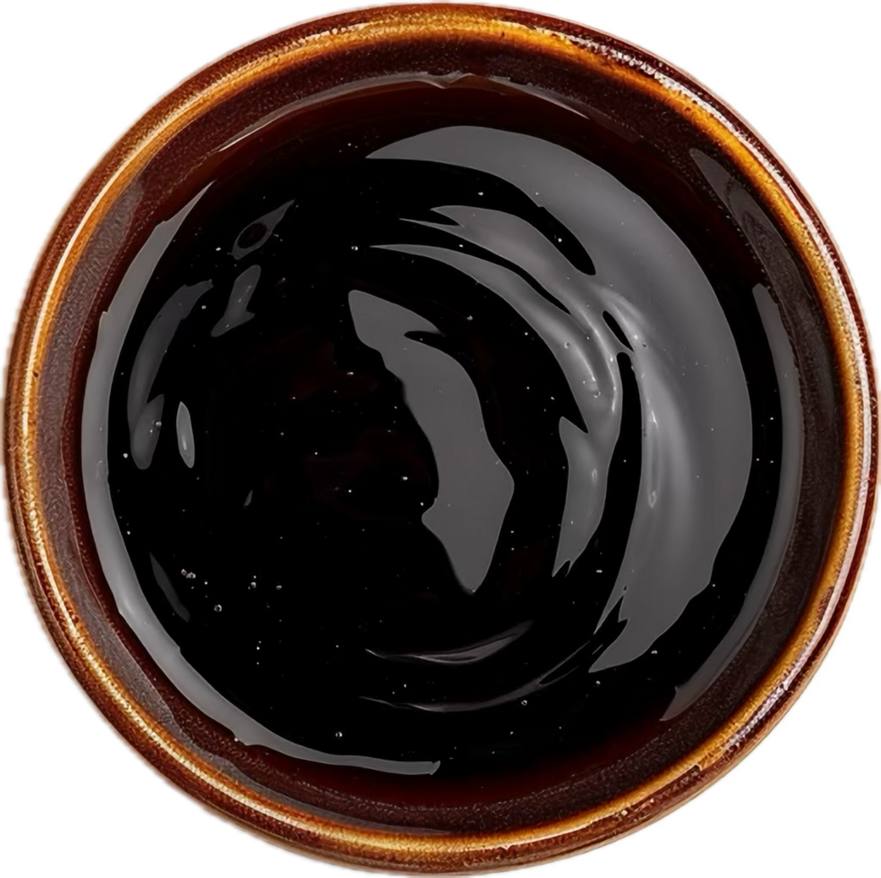 Top view of thick dark sauce in a bowl. png