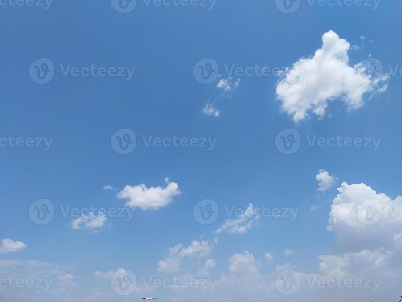 a blue sky with clouds and a few clouds photo