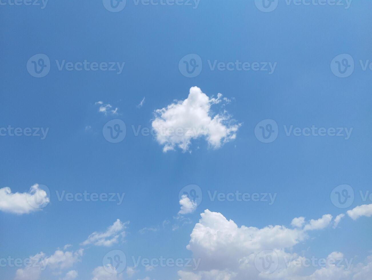 a large field with a few clouds in the sky photo