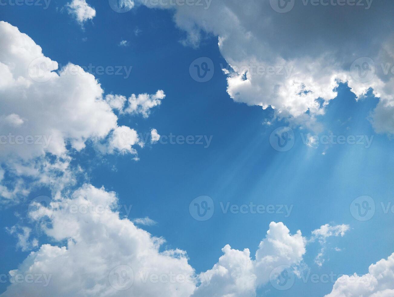 clouds and sun rays in the blue sky photo