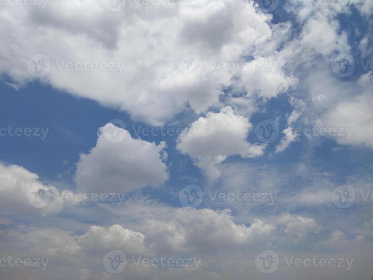 a view of the sky with clouds and a few trees photo
