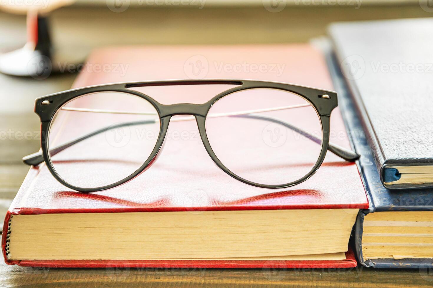 Close up Eye glasses and books photo