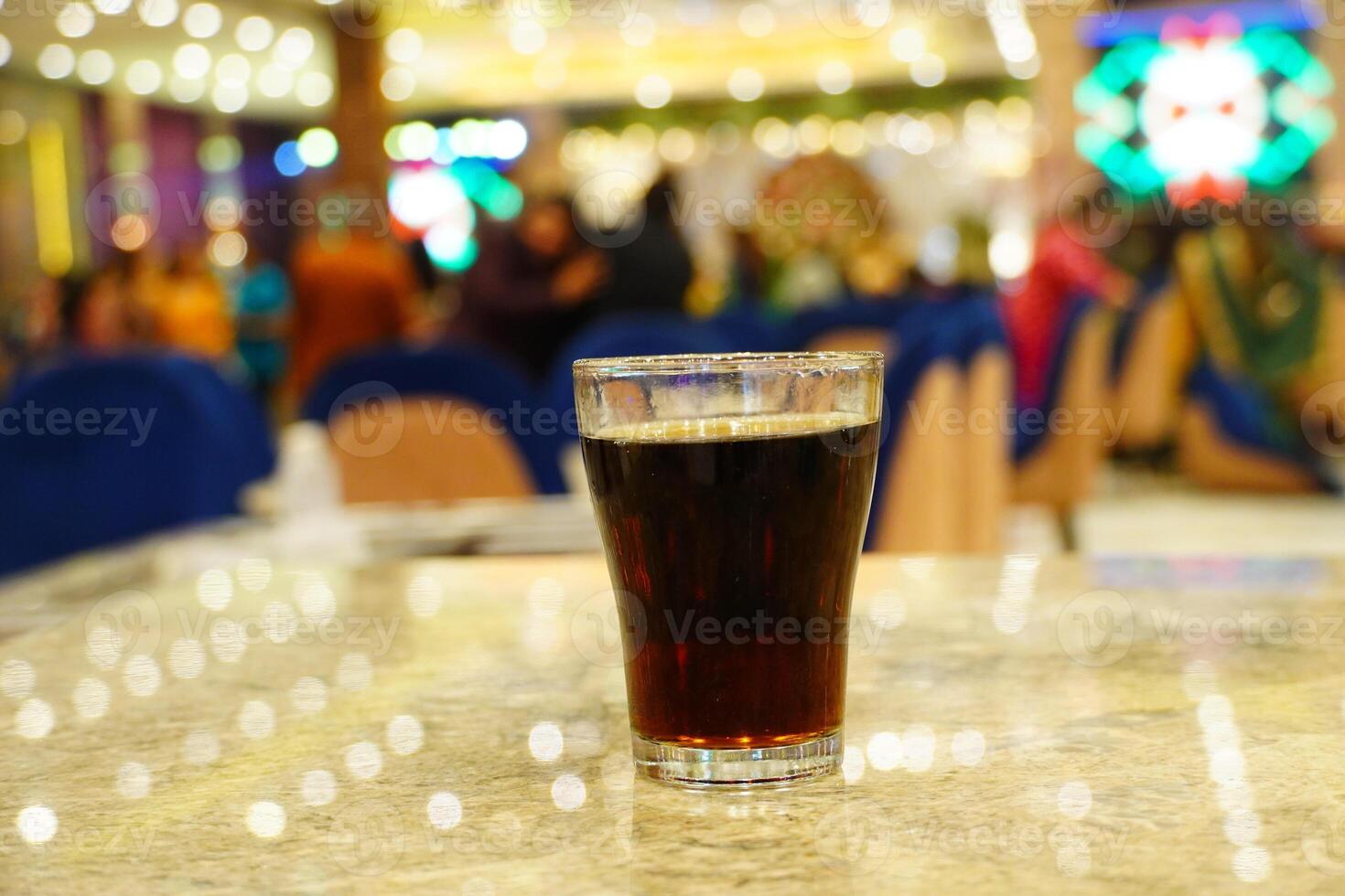 Close up of cold drink on the table with boken lights portrait background photo