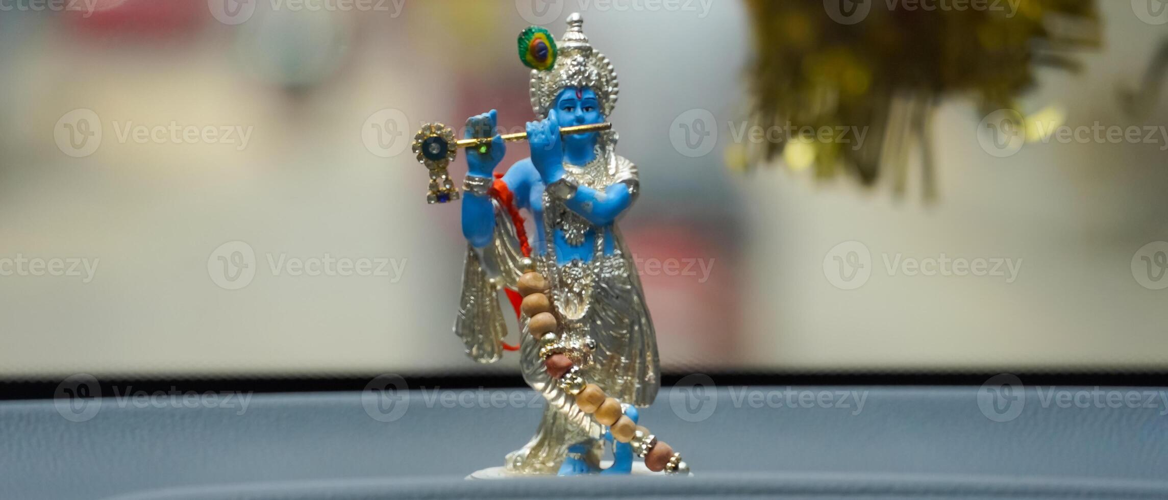Colorful figure of the Hindu God Krishna playing the flute landscape image photo