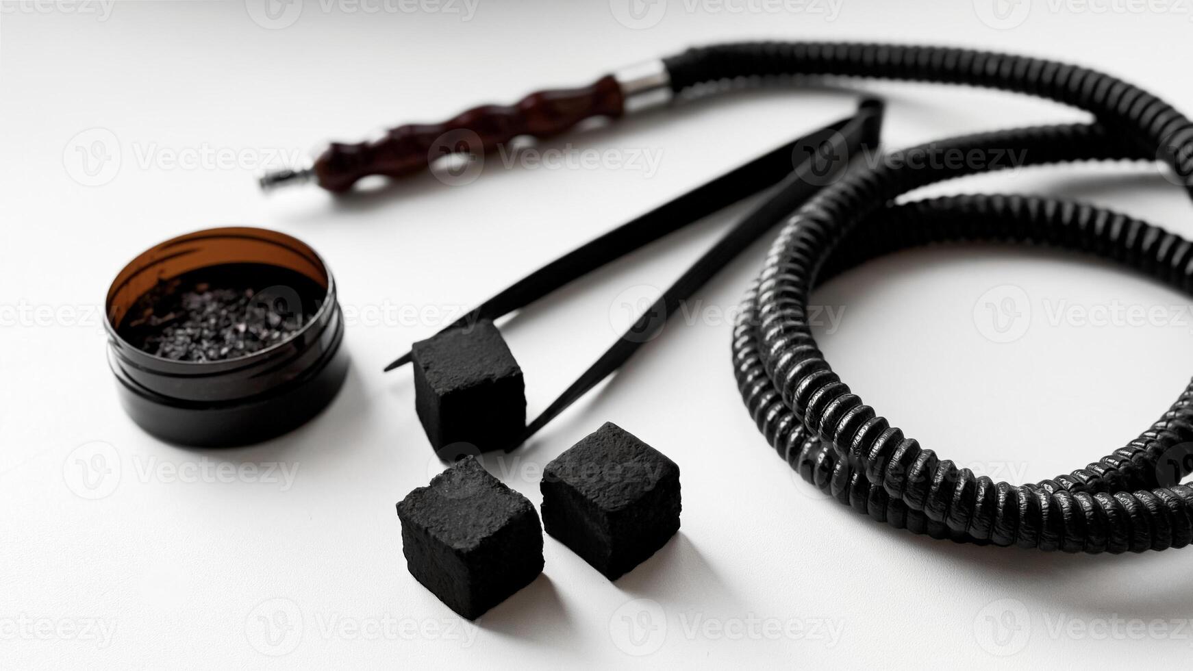 Hookah essentials charcoal cubes, hose, and accessories on white background photo