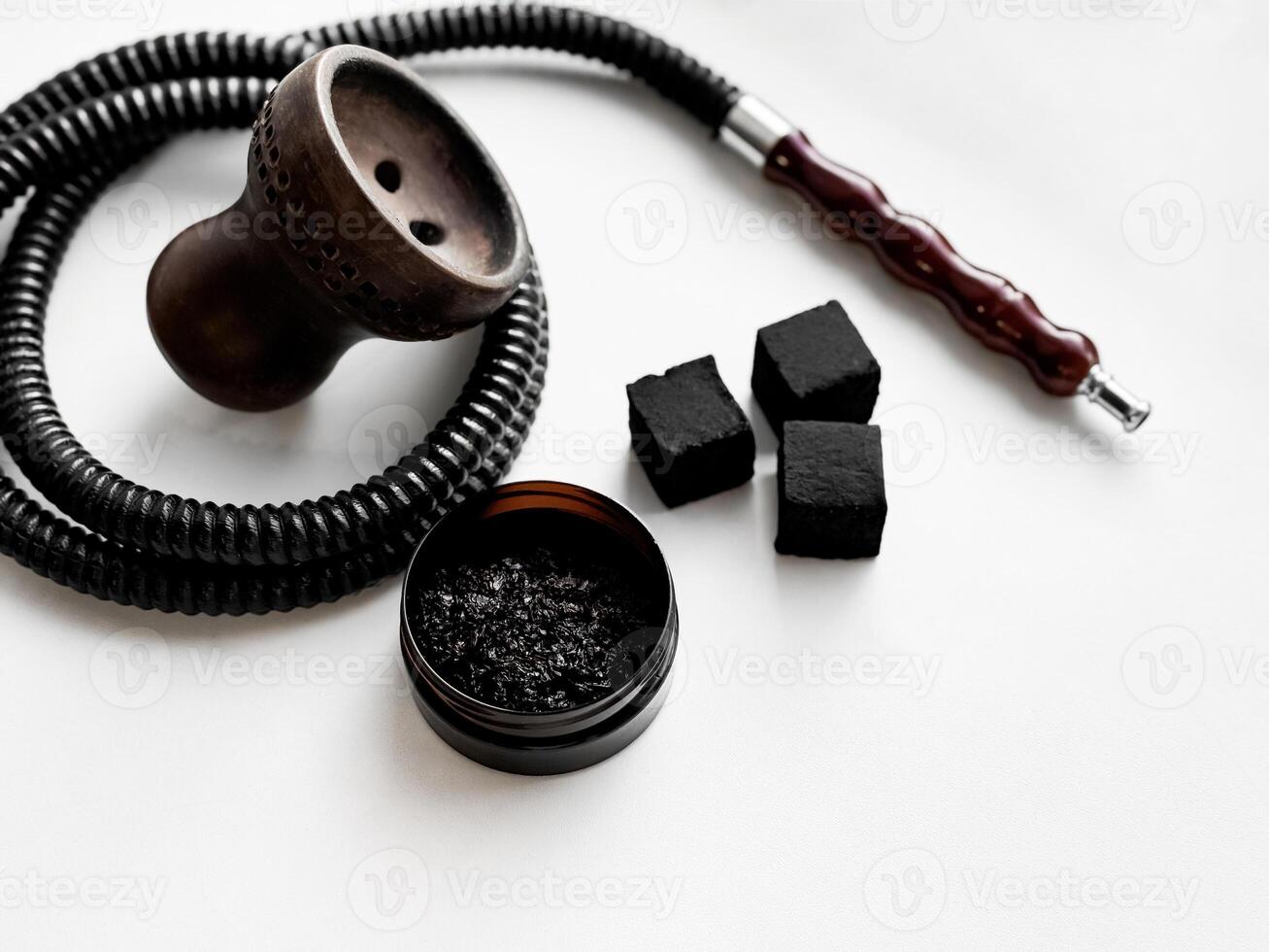 Traditional hookah components with charcoal cubes on white background photo