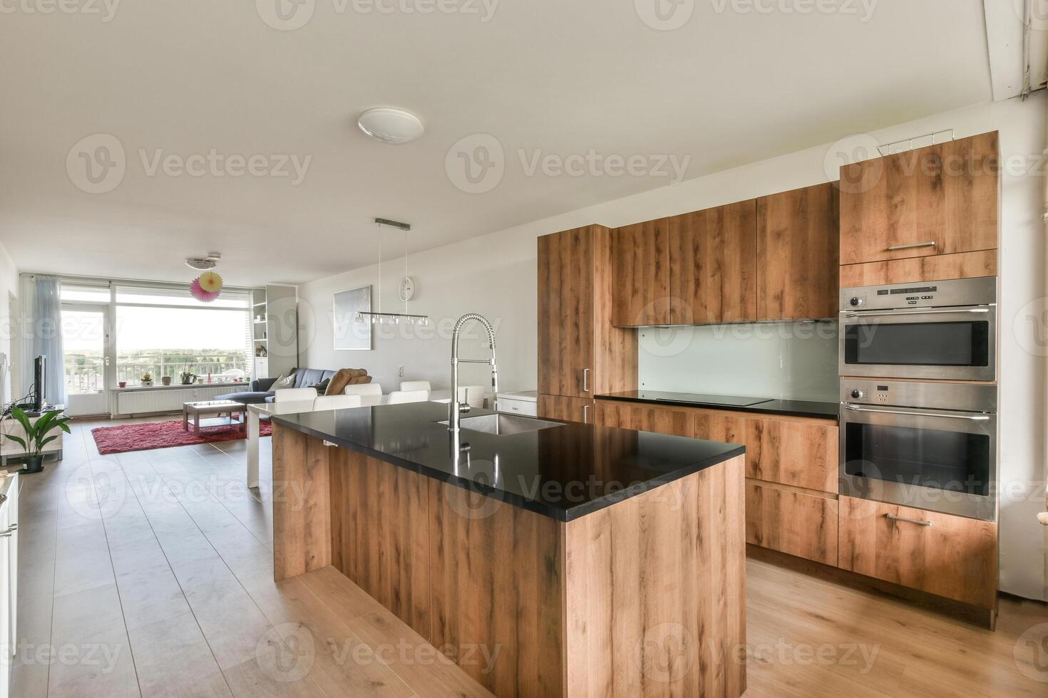 A kitchen with wooden cabinets and black counter tops photo