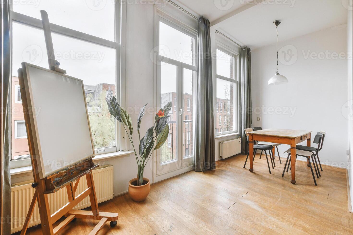 A room with a table, chair and easel photo