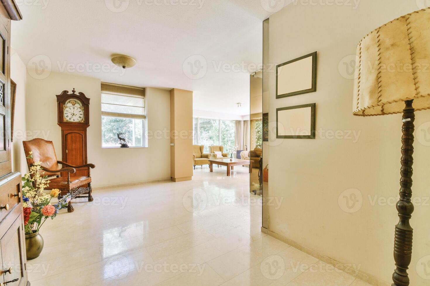 A hallway with a clock and a chair photo
