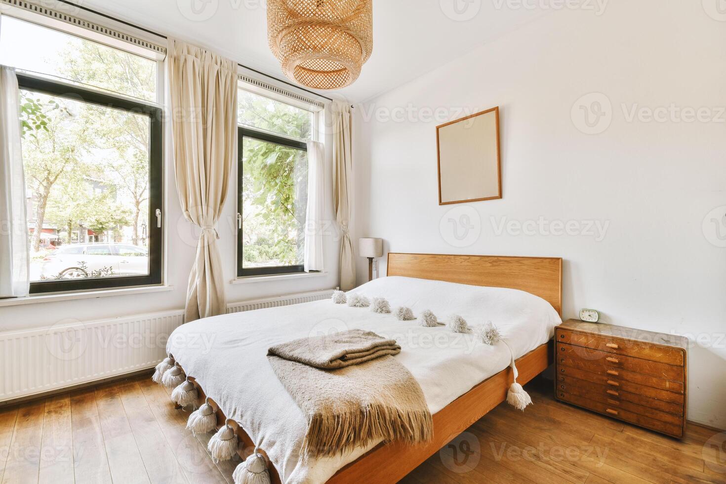 A bedroom with a bed, a dresser and a window photo