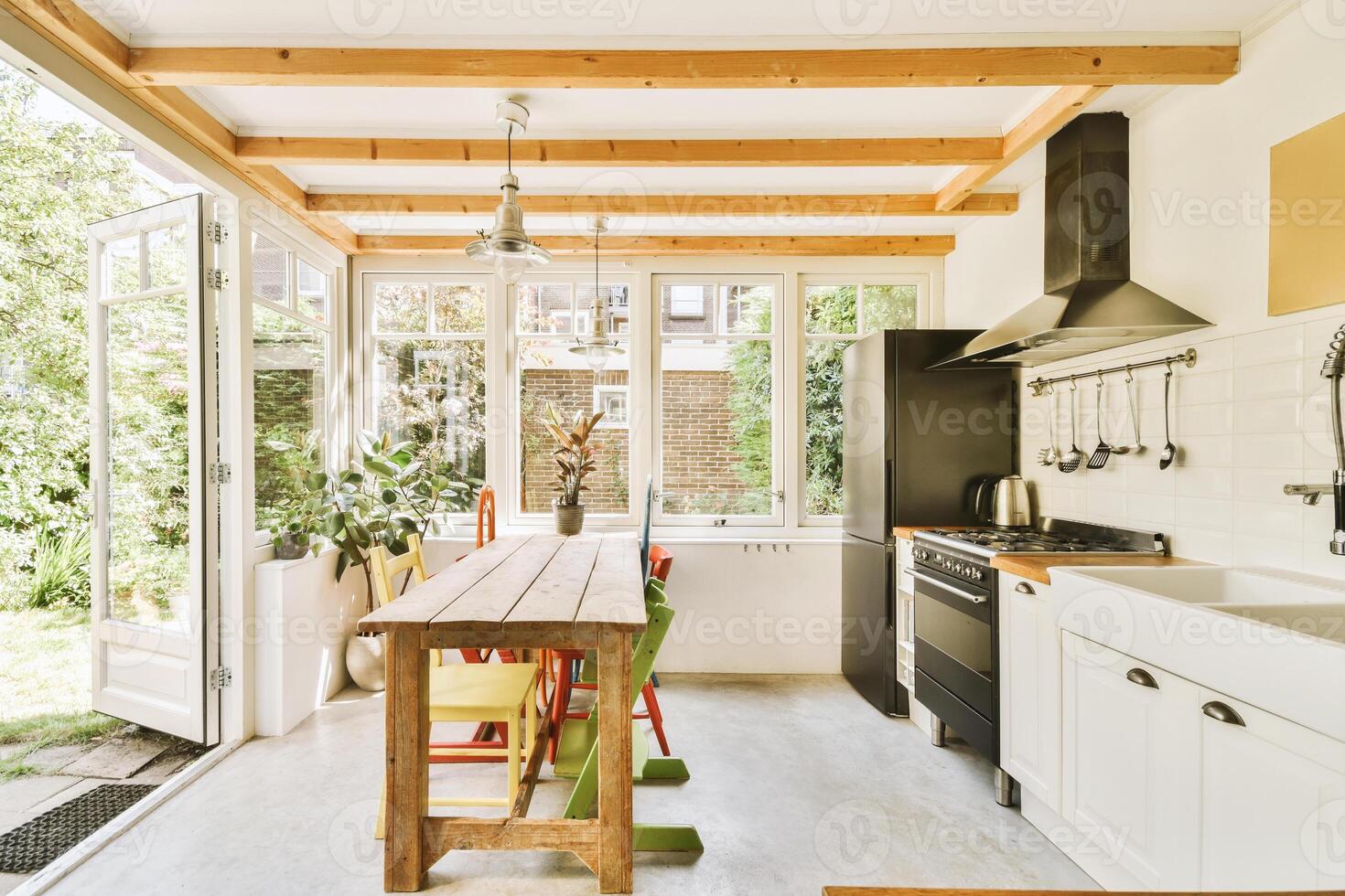 A kitchen with a table and chairs photo
