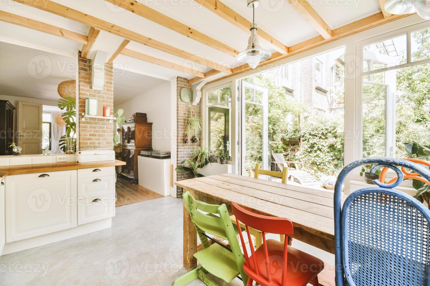 A kitchen with a table and chairs in it photo