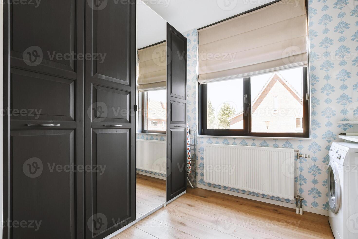 A room with a washer and dryer and a window photo