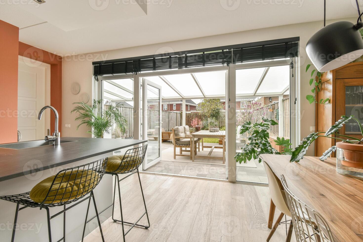 A kitchen with a dining table and chairs photo
