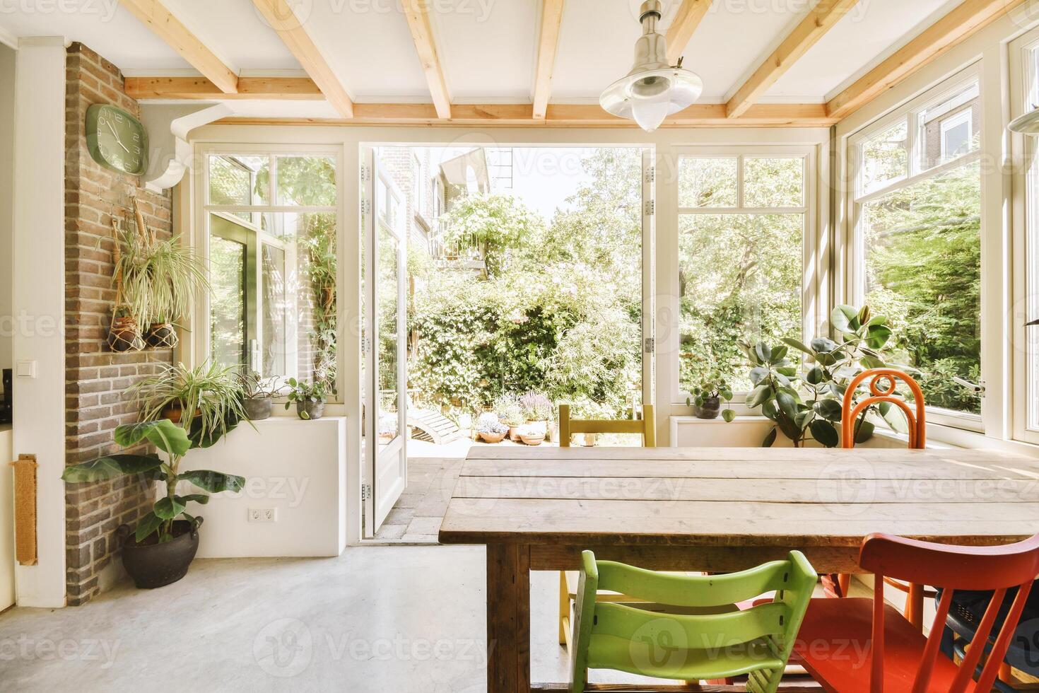 A sunroom with a table and chairs photo