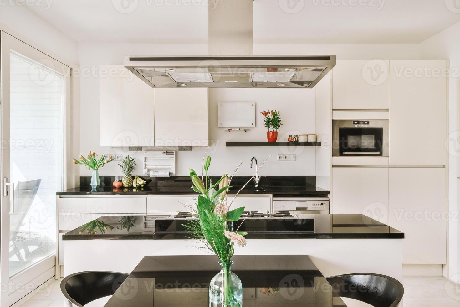 A kitchen with a table and chairs photo