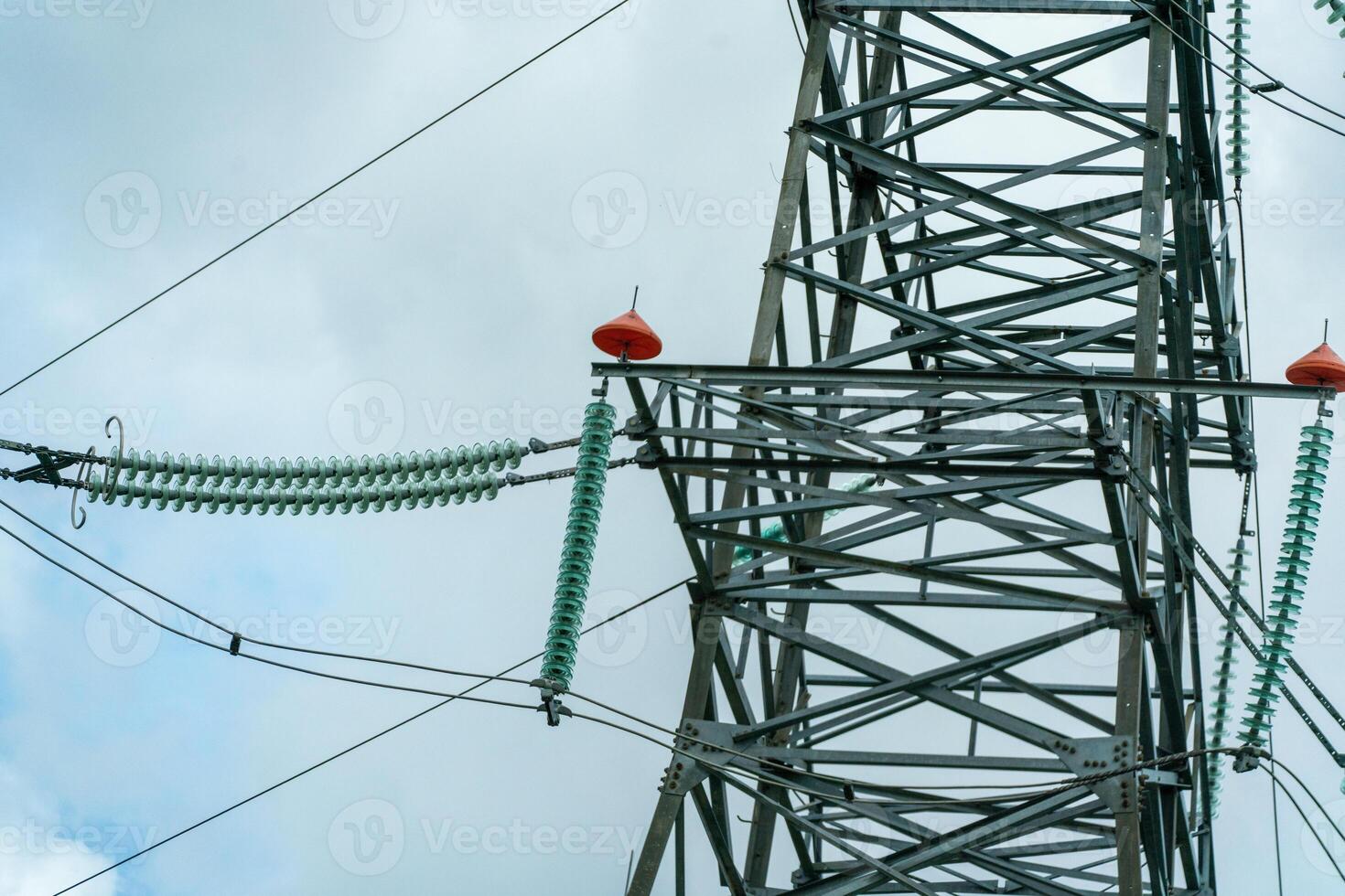 High voltage towers with sky background. Power line support with wires for electricity transmission. High voltage grid tower with wire cable at distribution station. Energy industry, energy saving photo