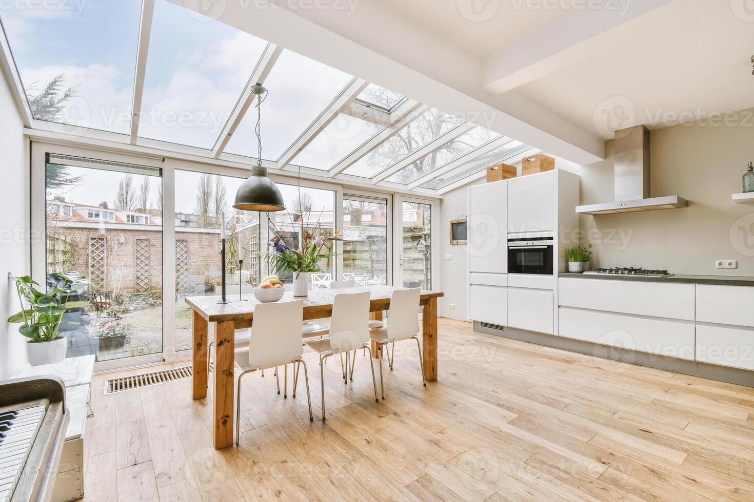 A kitchen with a table and chairs in it photo
